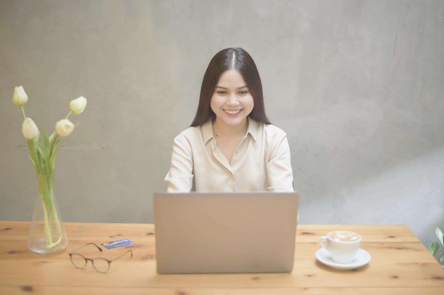 Business owner reviewing financial dashboard on laptop with coffee